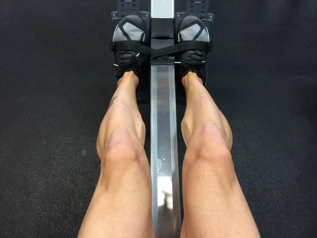 a woman is rowing at the gym