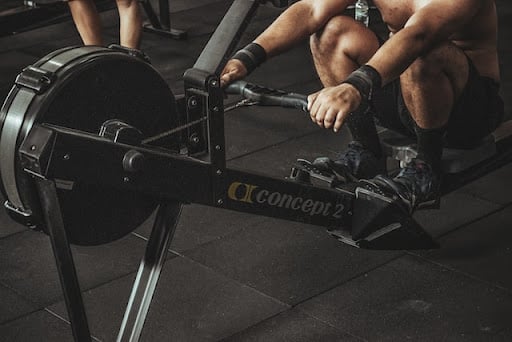 a man trying rowing machine to understand if it is a good workout