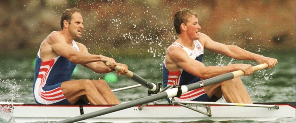 Two men rowing to get the most of their rower body