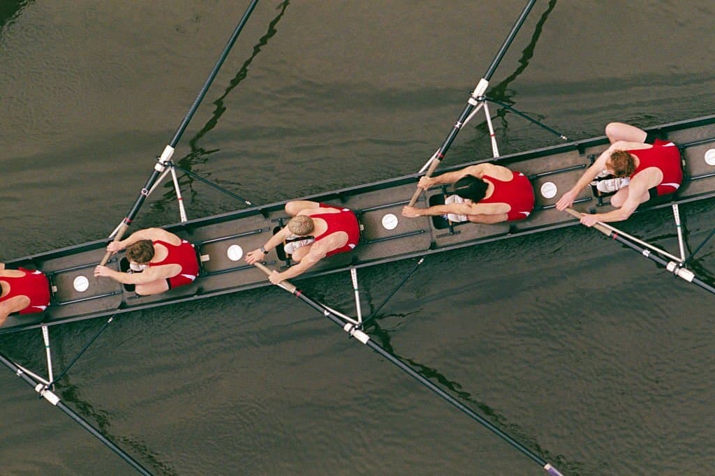 a team pushing their body during a rowing workout