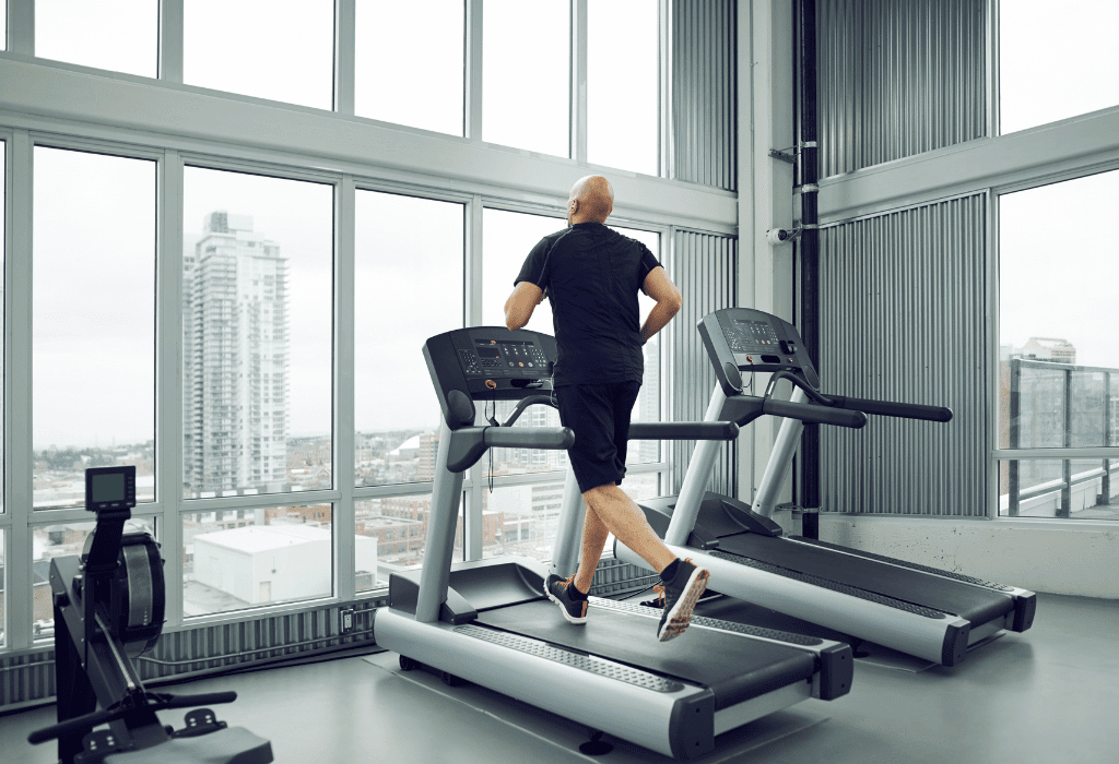 A man testing a treadmill to write a guide to buying treadmills