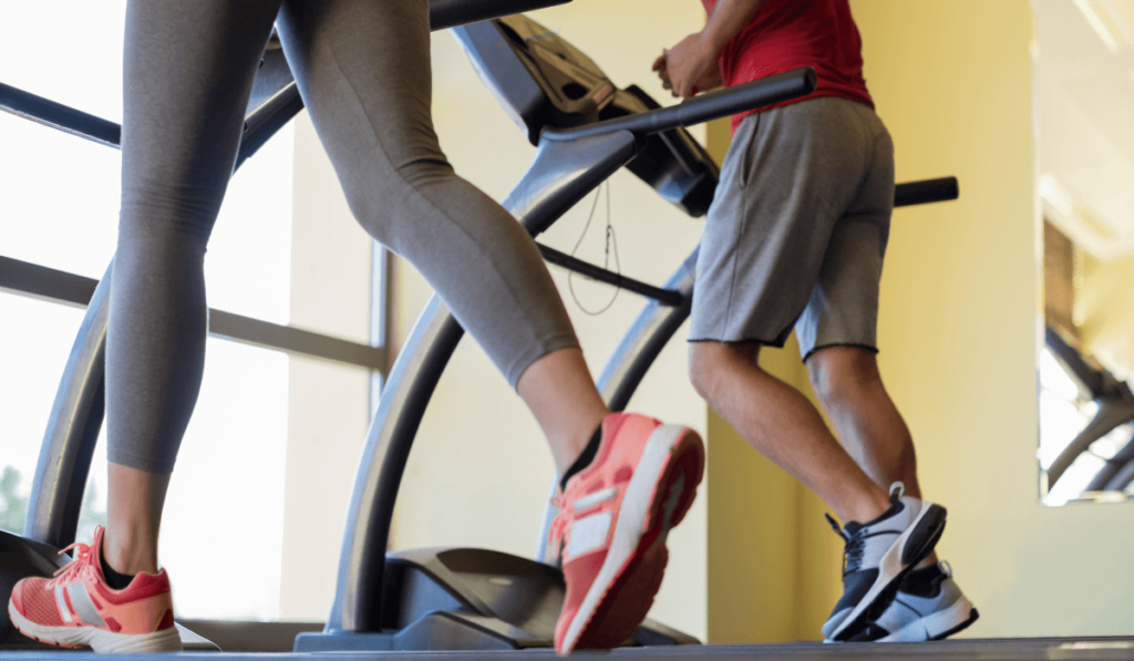 Two people running on a treadmill