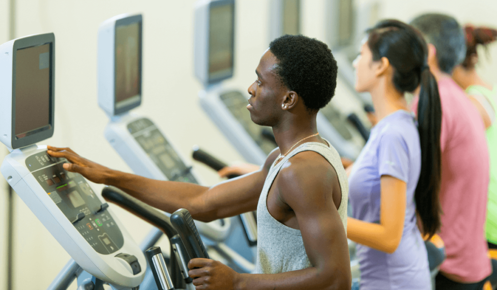 A man working out after discovering how long on elliptical to see results it takes