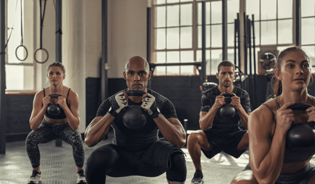 A group of people working out to reach kettlebell results