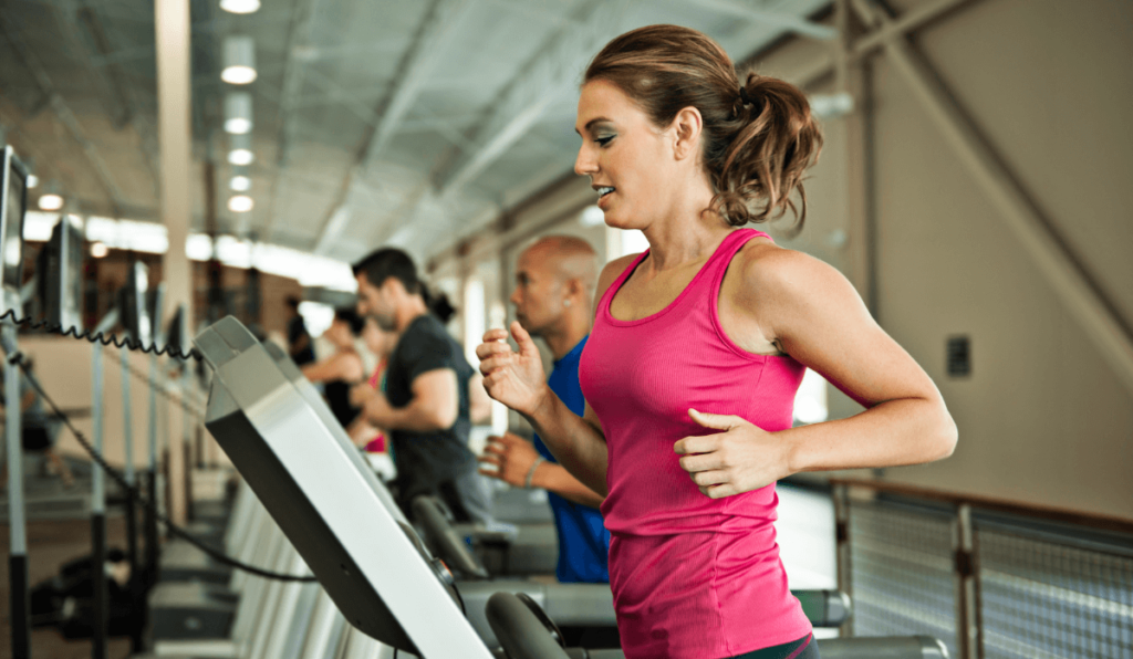 A group of people running on treadmills