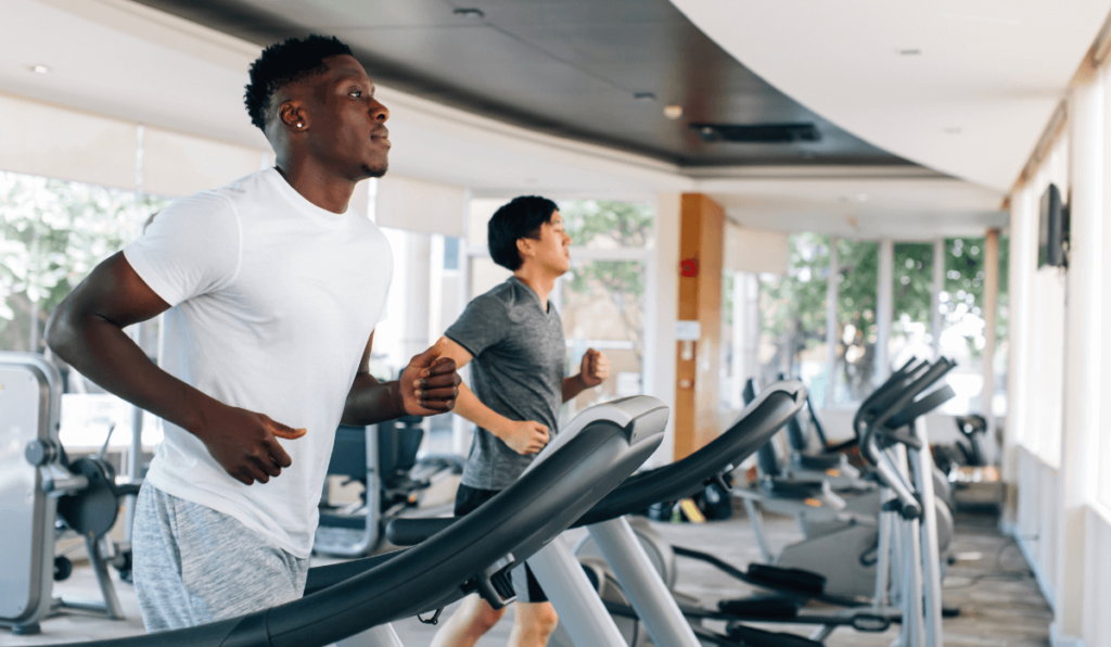 Two friends working out on treadmills