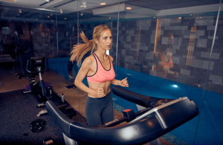 A woman running on the best manual treadmill