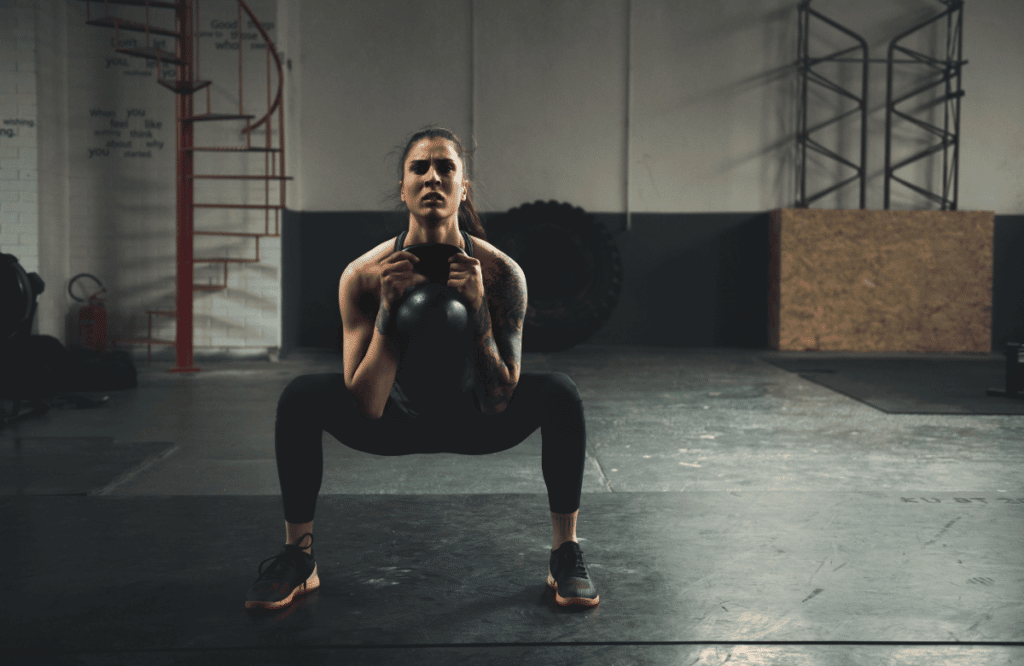 An athlete at the gym doing kettlebell workouts for women