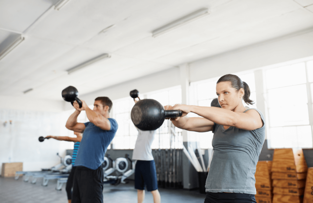 A group of people trying cardio kettlebell workout