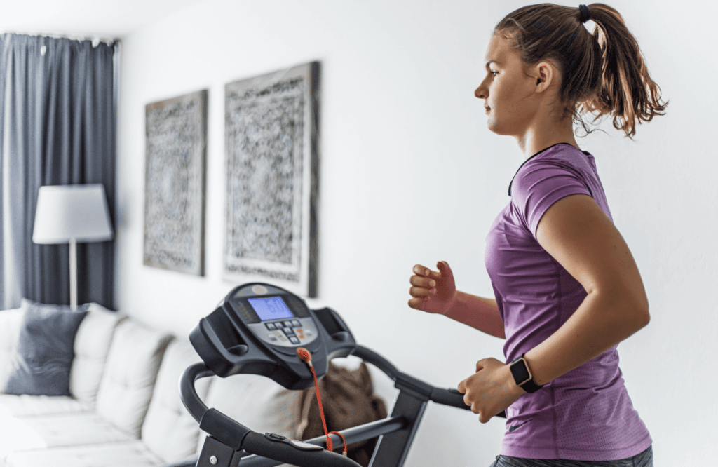 A woman running on a fast treadmill at home