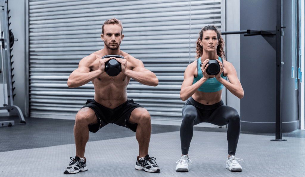 Two people doing kettlebell windmill exercise