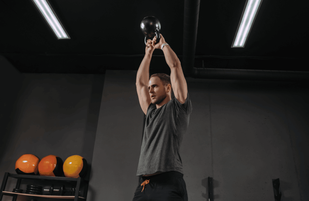 A man doing kettlebell halo exercises for his workout
