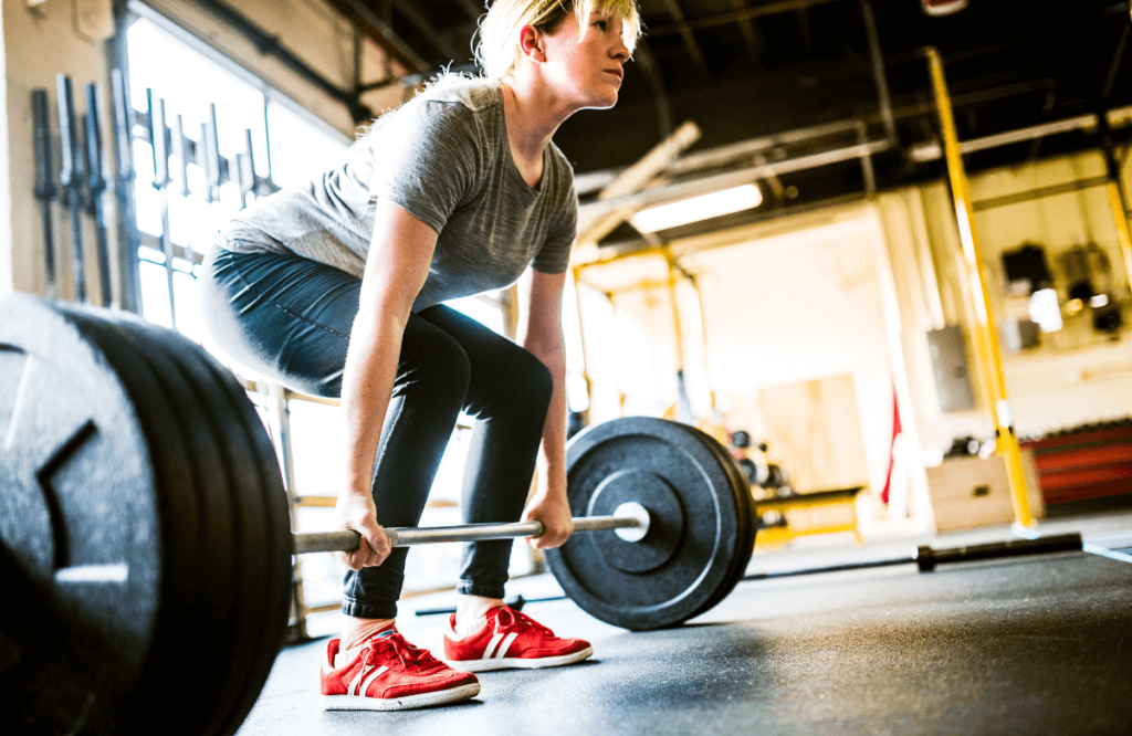 A woman working out trying different types of deadlifts