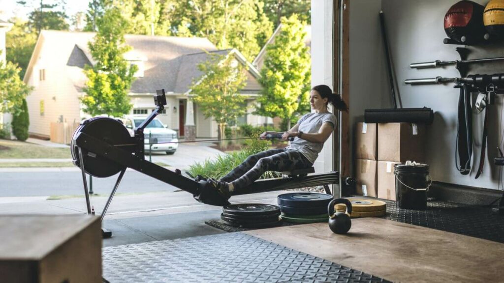 A woman using the rower in her garage after seeing the concept 2 model d reviews