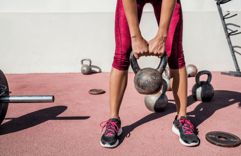 A woman training with the kettlebell windmill exercise