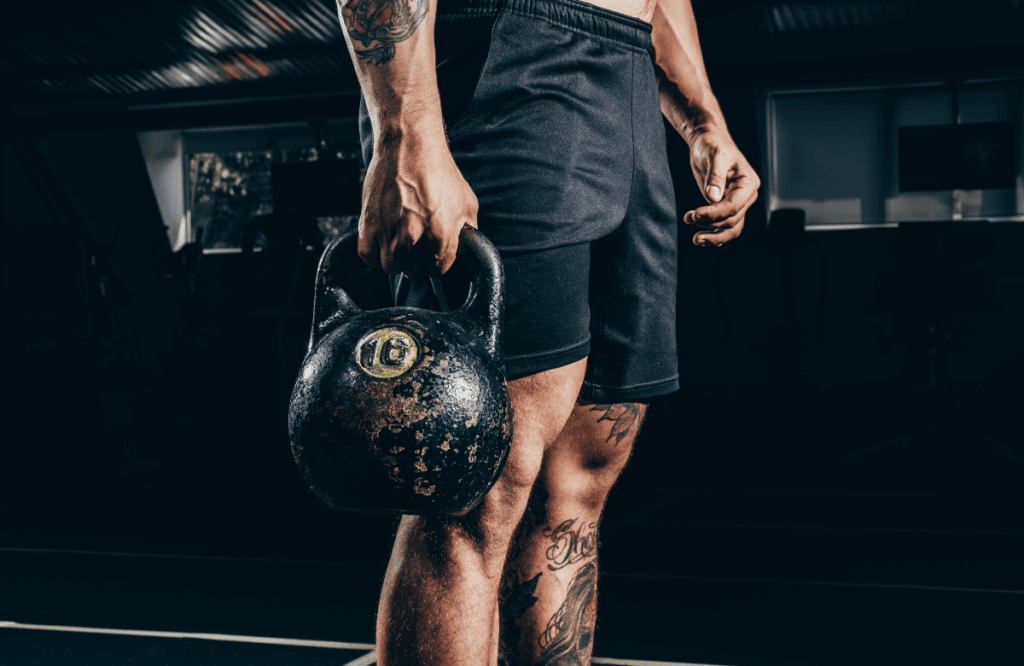 A man preparing for the kettlebell windmill exercise