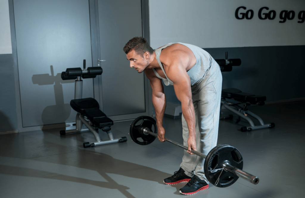 A man feeling lower back pain injury while deadlifting