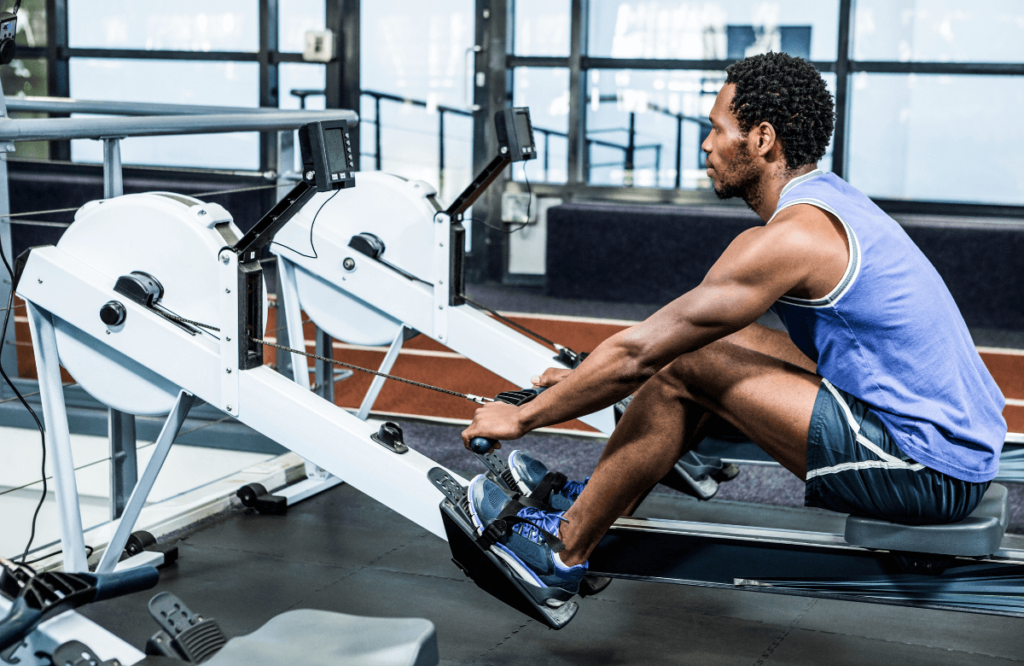 A man at the gym wearing the best shoes for rowing machine