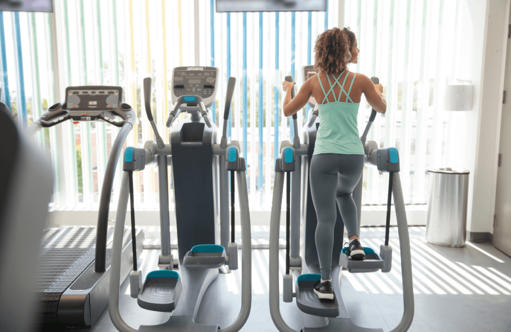 A woman at the gym using the best elliptical under $300