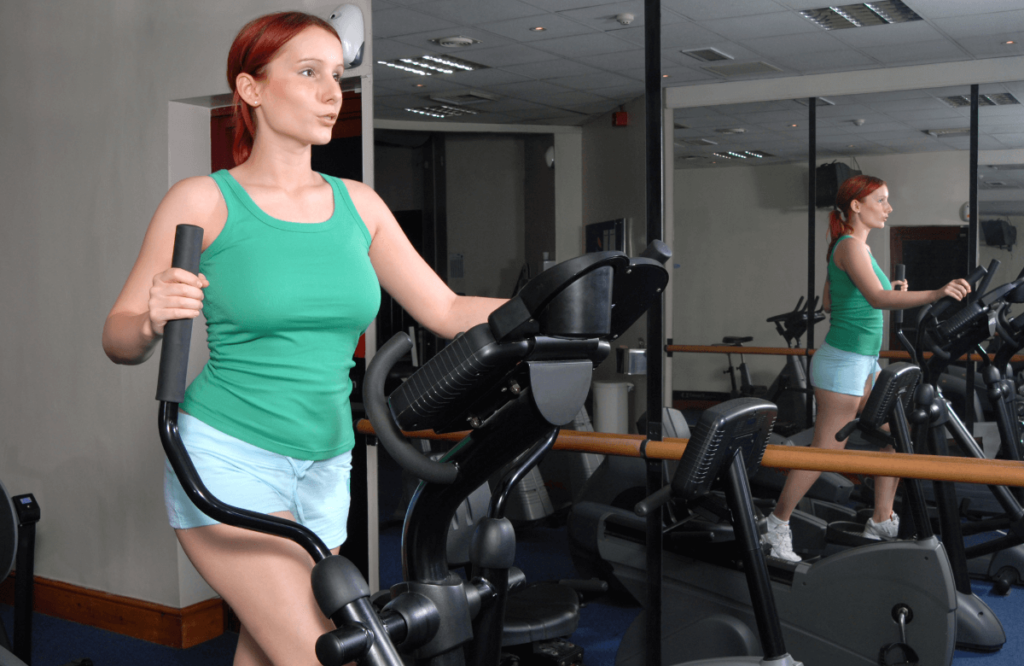 A woman using an elliptical after reading horizon ex59 elliptical reviews