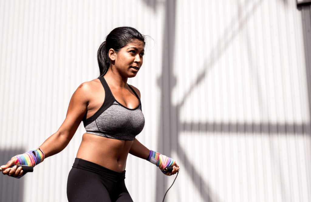 A woman working out outside to compare cardio vs weights for weight loss