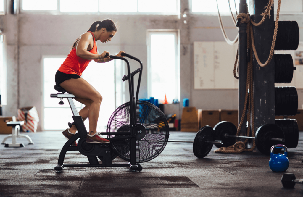 A woman on an elliptical to compare cardio vs weights for weight loss