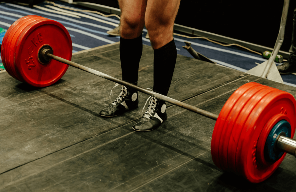 A man preparing his lifting with a deadlift bar weight