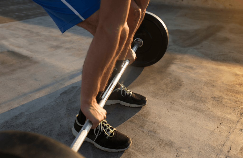 A man performing a stiff leg deadlift at the gym