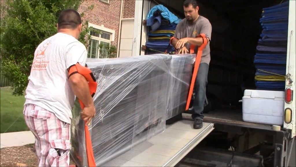 Two men knowing how to move a treadmill