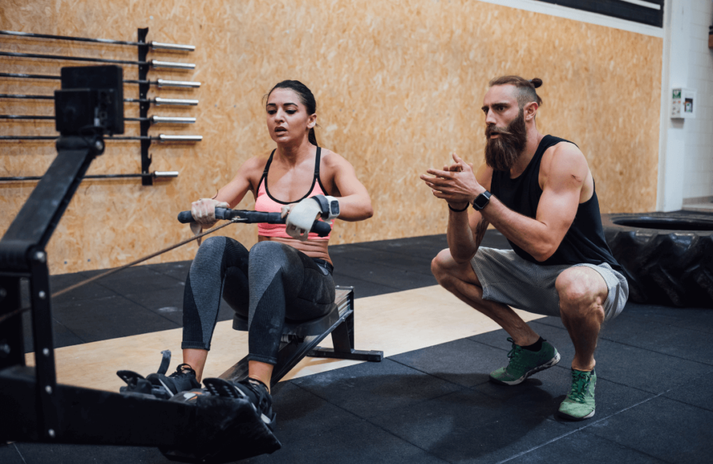 A woman and her coach using the best crossfit shoes
