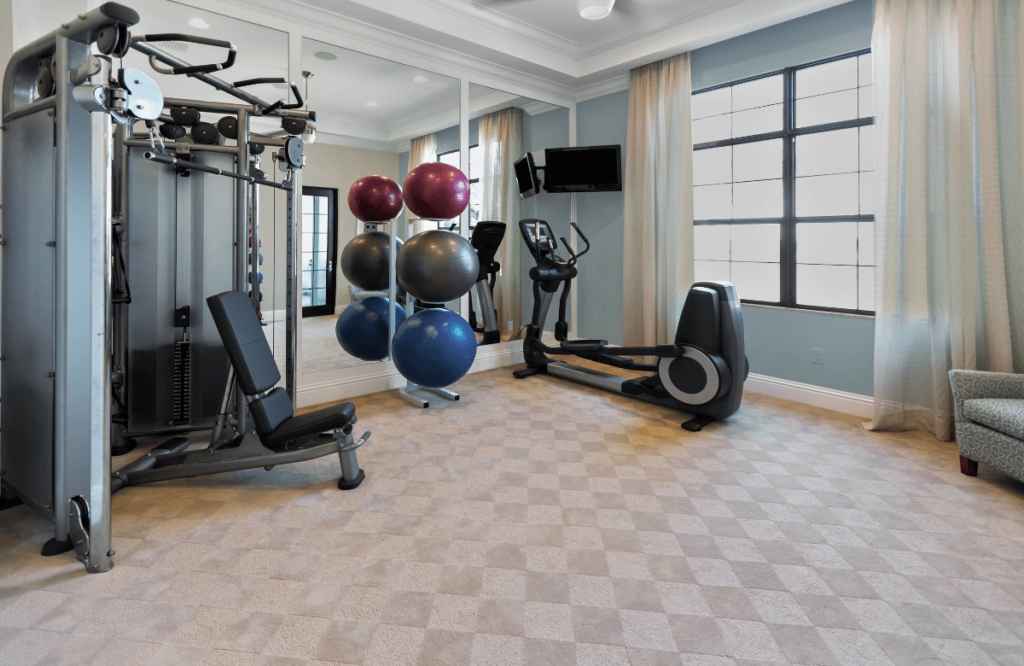 A home gym with many machines after the owner read a Nordictrack commercial 14.9 elliptical review