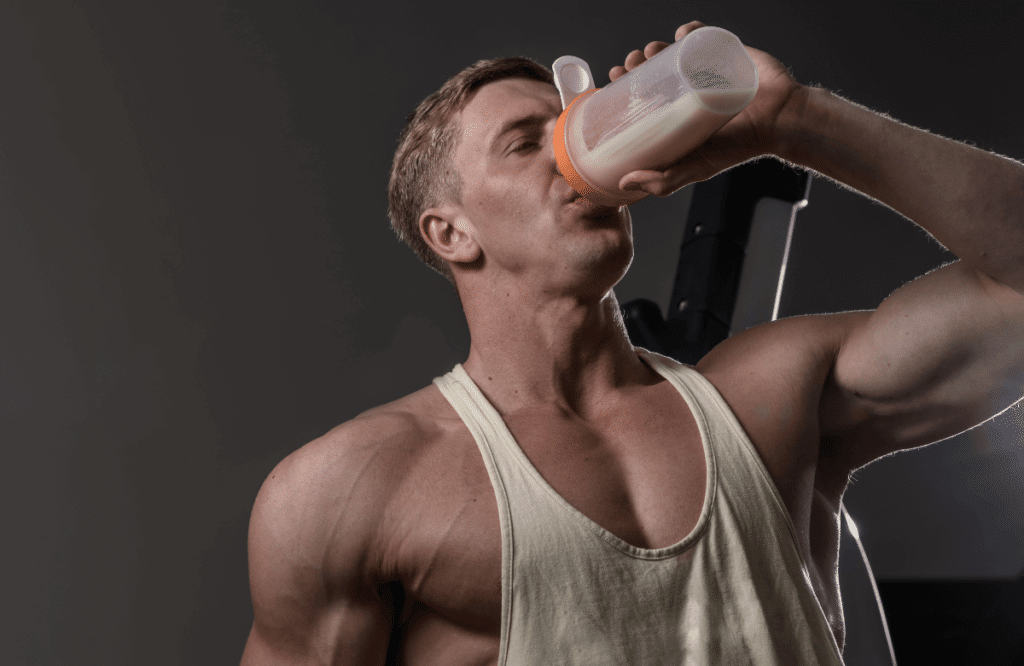 A muscular man drinking the best stim-free pre-workout