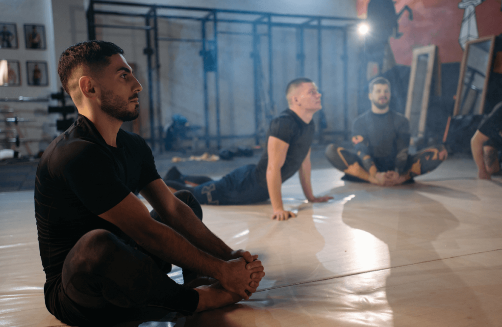 Men at the gym stretching to build muscle