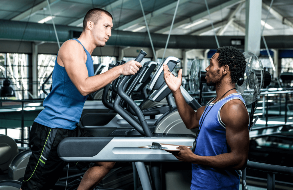 A man asking his coach what muscles do the elliptical work