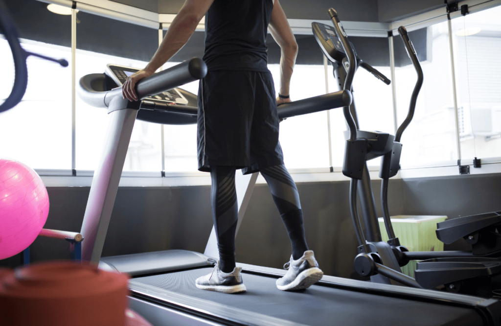 A man running on a treadmill at the gym