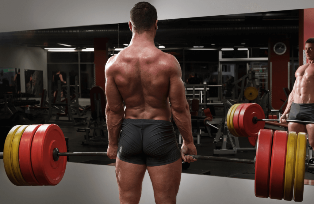 An athlete at the gym performing deficit deadlifts