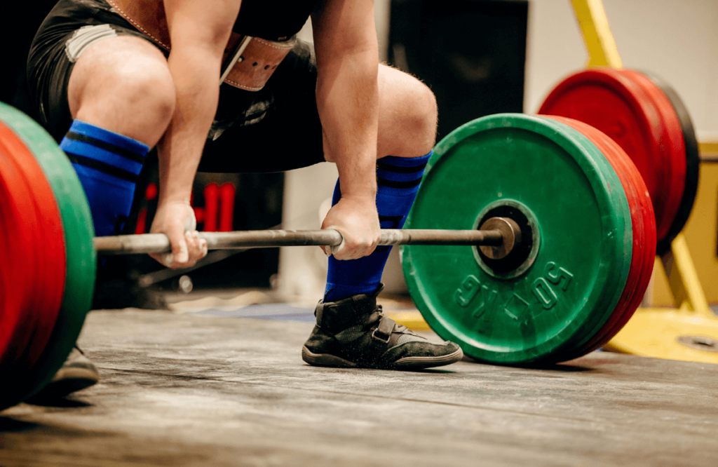 An athlete doing block pulls at the gym