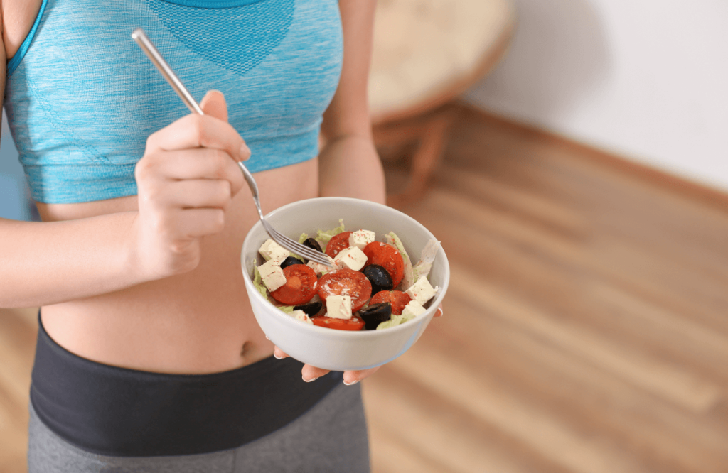 A woman eating lightly after finding how to get rid of pre-workout side effects