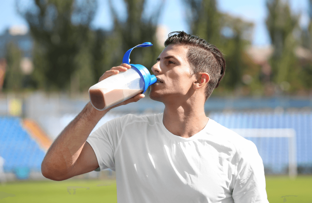 An athlete drinking a protein shake to avoid pre-workout side effects