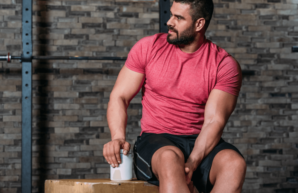 A man at the gym with a pre-workout box