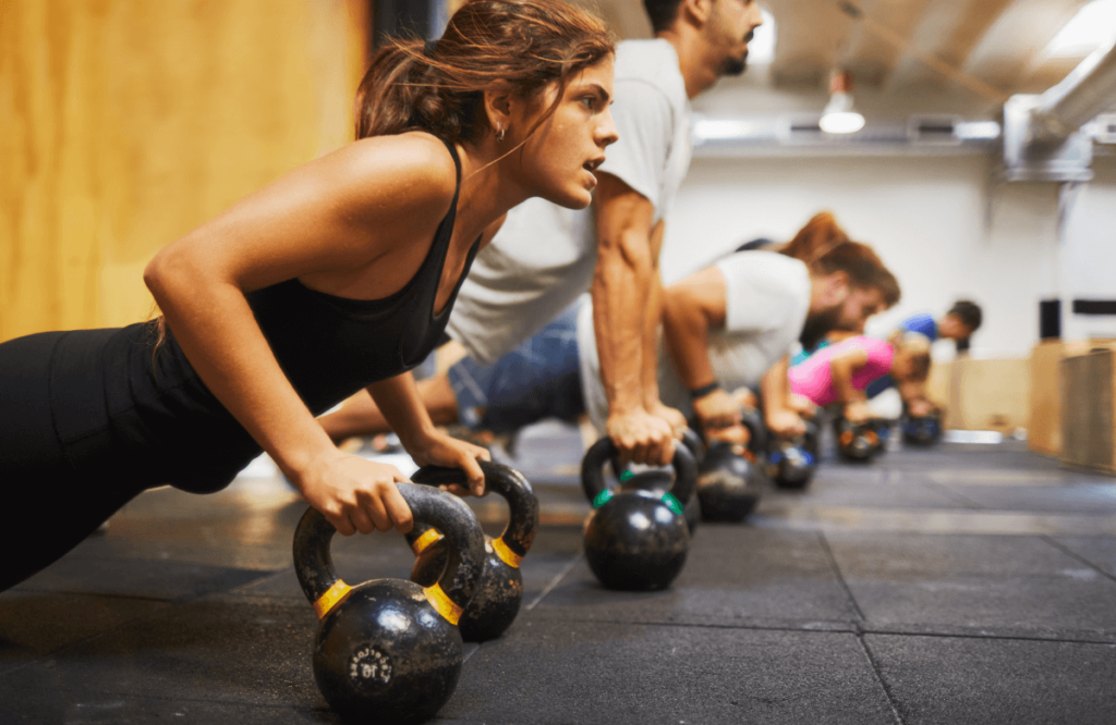 A woman working out at the gym after finding out how long is required to build muscle