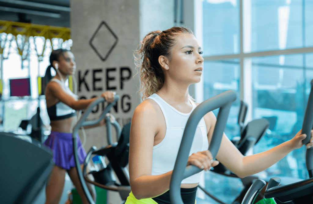 Women at the gym using the most best budget elliptical