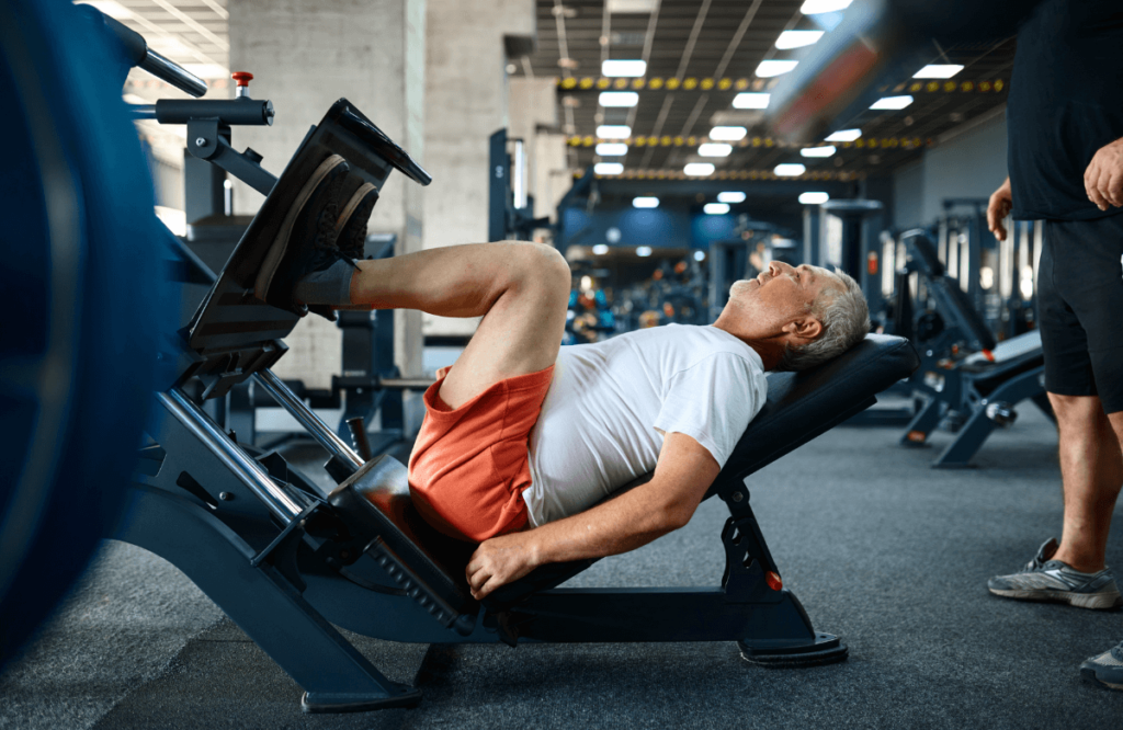 A man at the gym building muscle after 50 with leg press