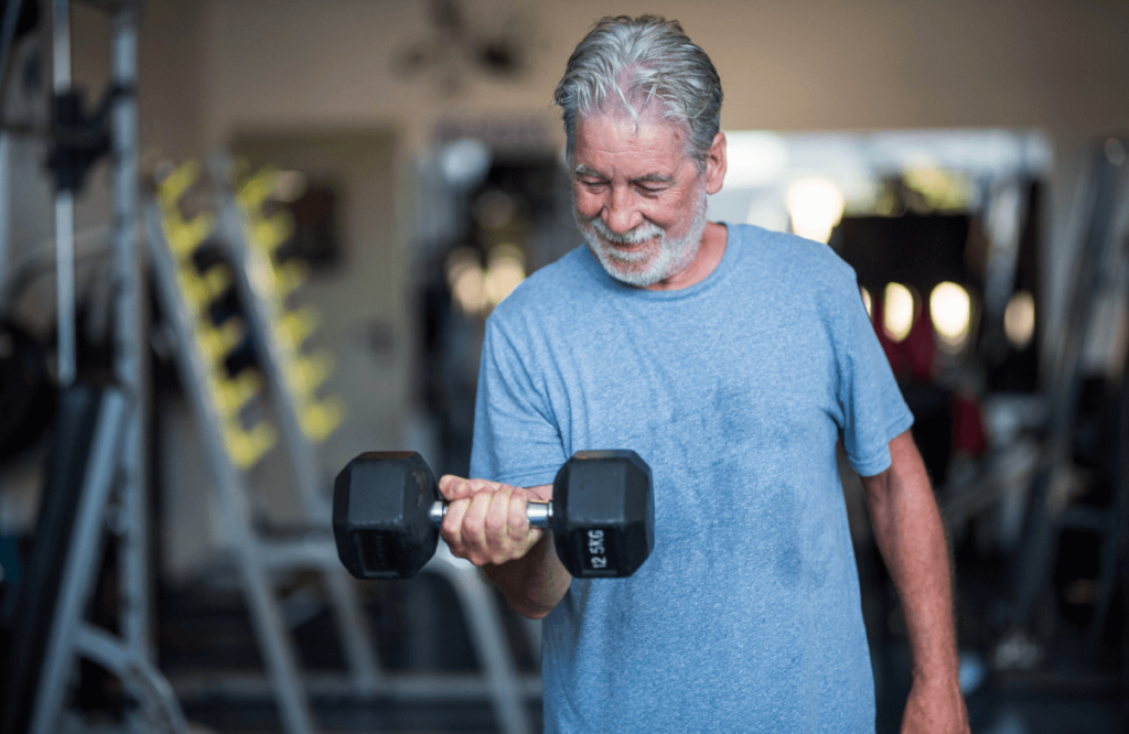 A man building muscle after 50 with a dumbbell