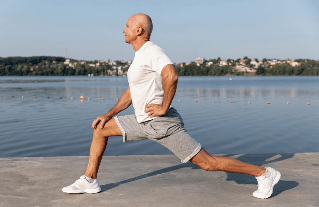 A man outside stretching while building muscle after 50