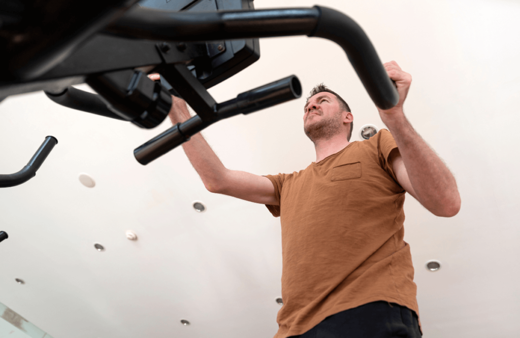 A man using an elliptical after reading a Sole E35 elliptical review