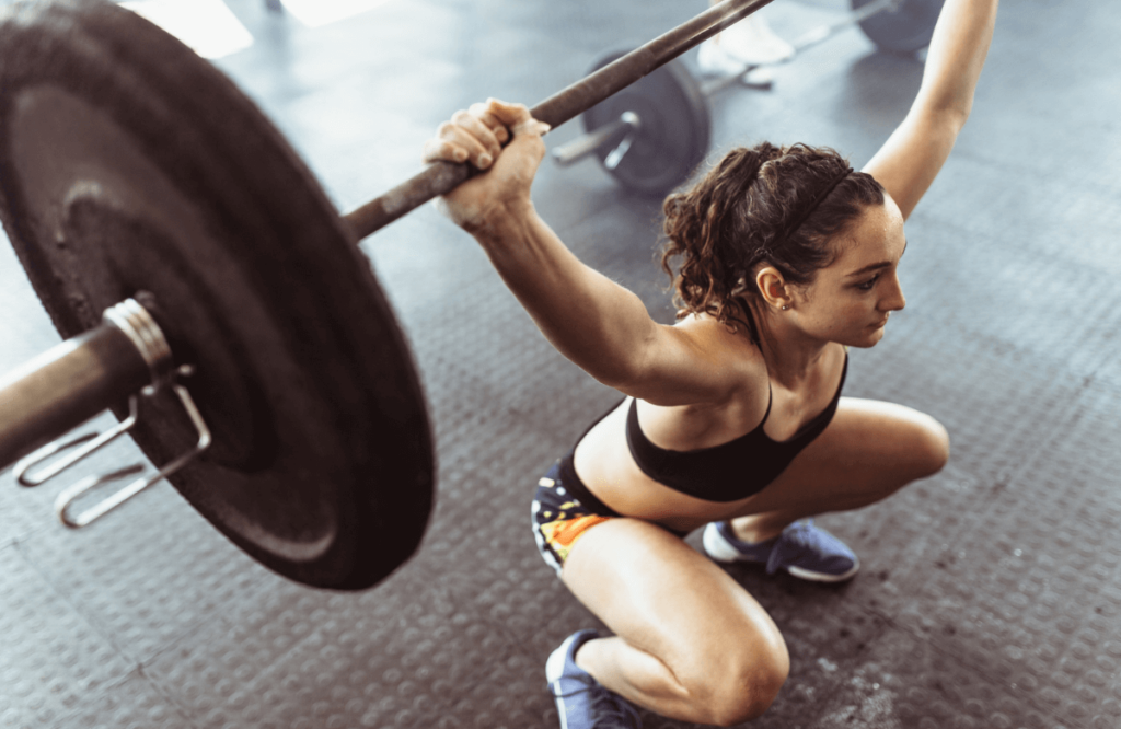 A woman performing the best deadlifts for glutes at the gym