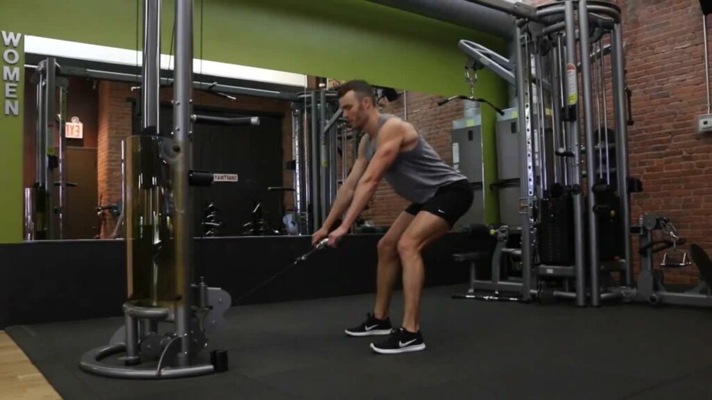 An athlete performing cable deadlifts at the gym