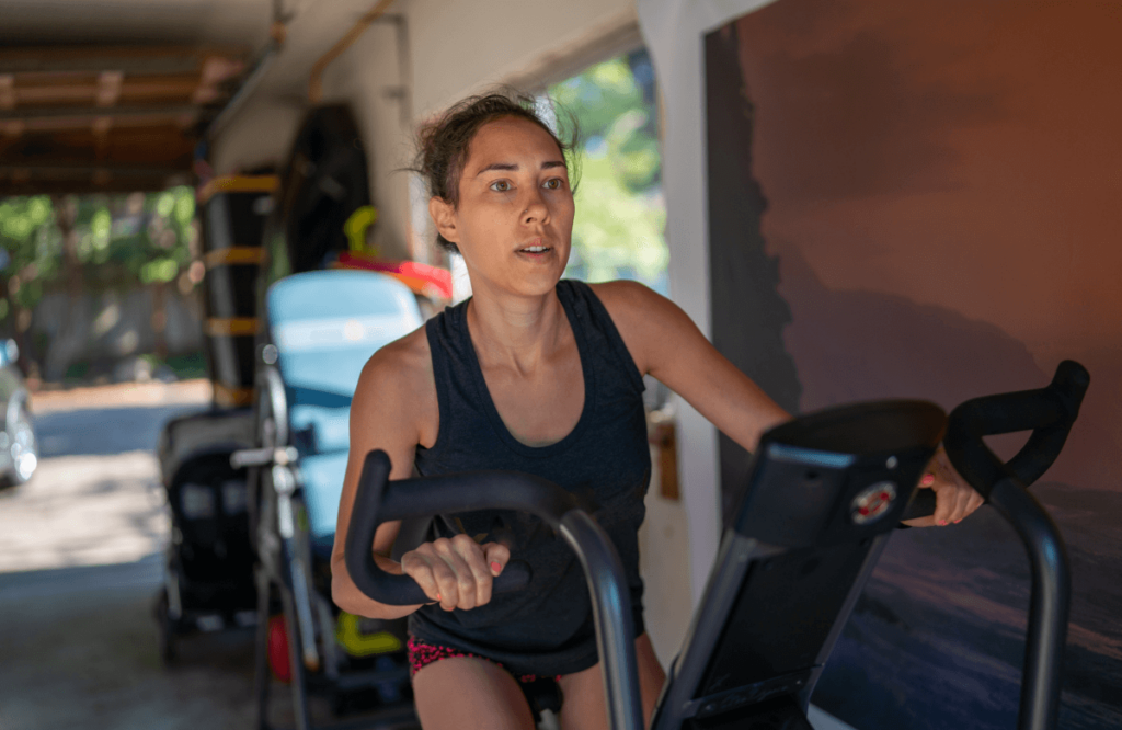 A woman using the best cheapest elliptical in her garage