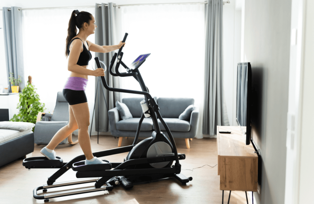 A woman at home using the best cheapest elliptical